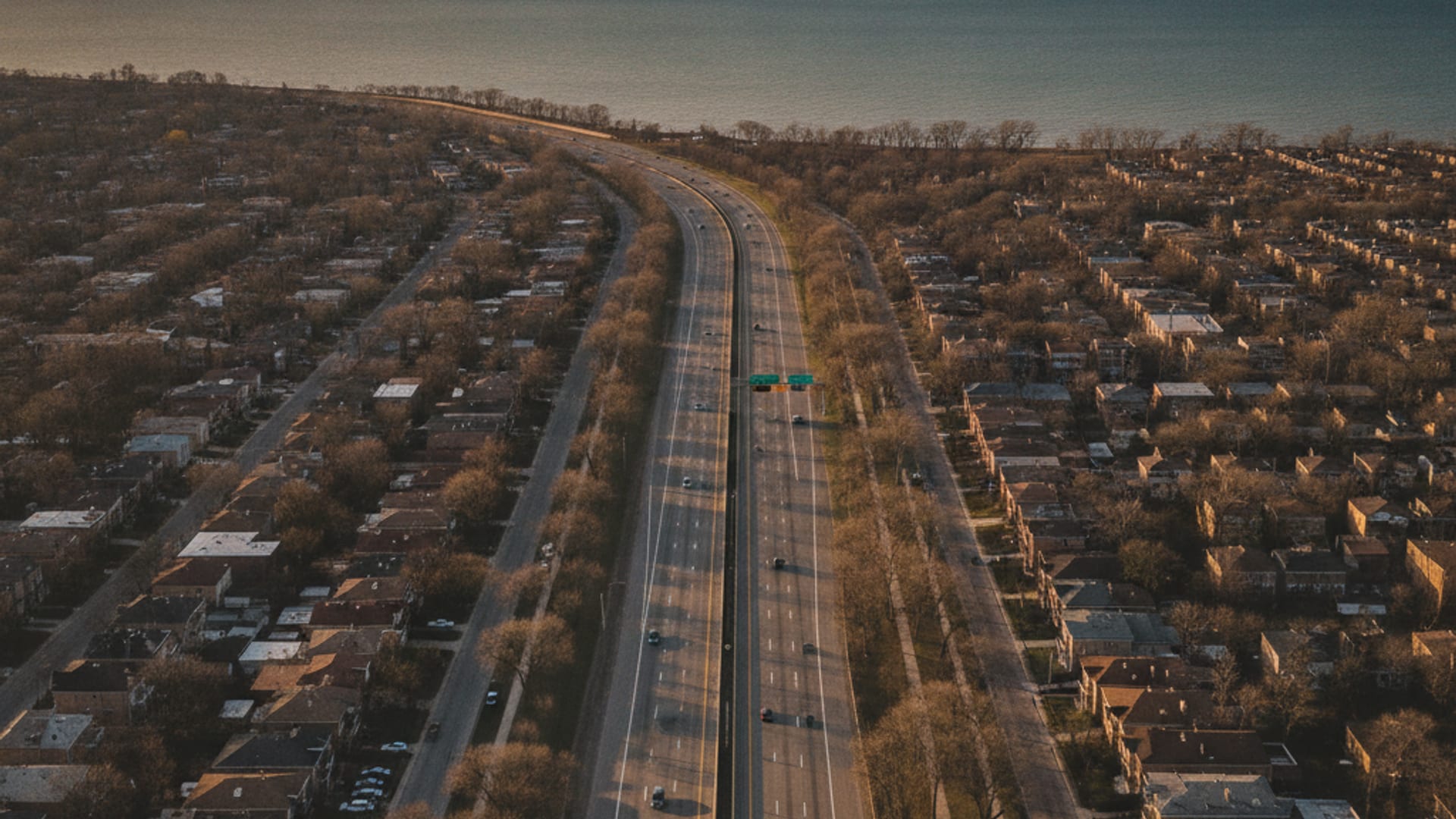 Aerial view of Chicagoland freeway network at golden hour showing lakefront Chicago through inland Naperville to southwest Joliet
